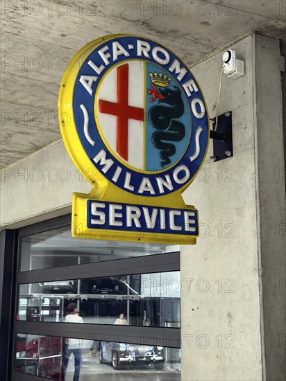 Old historic neon sign with coat of arms and Alfa Romeo Milano lettering, Classic Remise,