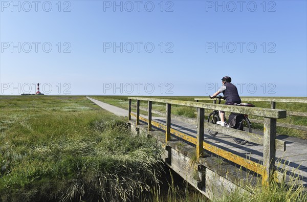 Cycling at the Westerheversand lighthouse, Schleswig-Holstein, Germany, Europe