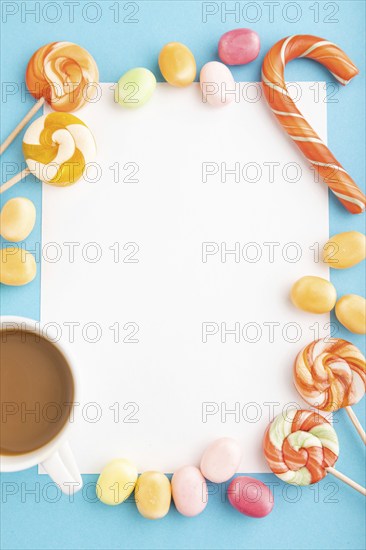 Composition with candies frame on blue pastel background. copy space, top view, flat lay, template