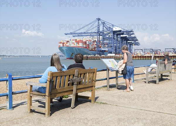 People at Landguard with container ship in background, Port of Felixstowe, Suffolk, England, UK