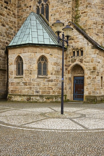 Cobblestones and lantern with part of St Laurentius Church in Warendorf, Warendorf district, North
