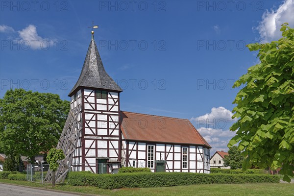 Half-timbered church in Wenze, stabilised against collapse with squared timbers, in the UNESCO