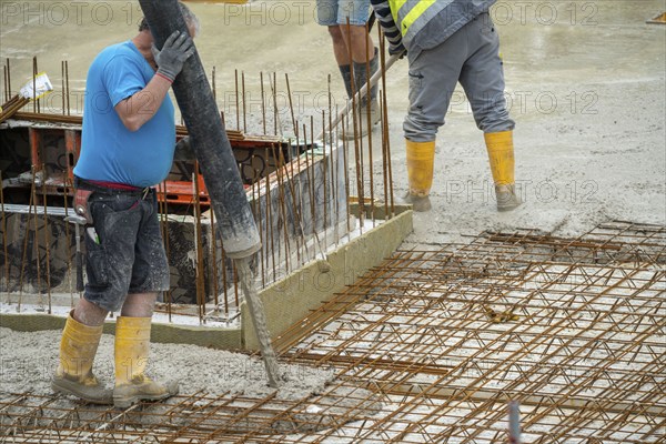 Construction site, concreting, the floor slab of a building is concreted, the concrete is pumped