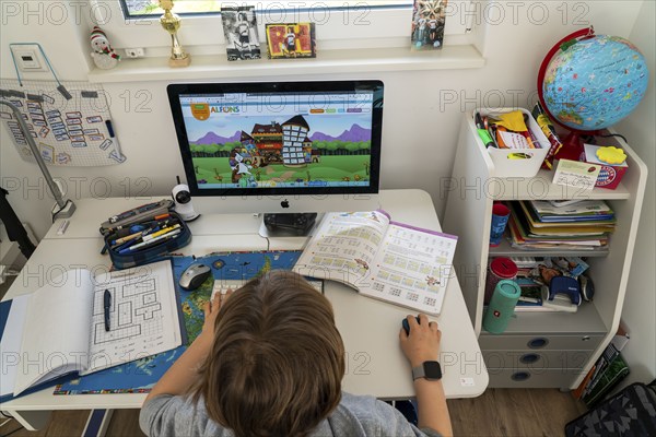 Young, primary school pupils, home learning, doing schoolwork, distance learning, virtual