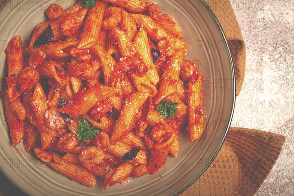 Penne pasta, with shrimp in tomato sauce, close-up, no people