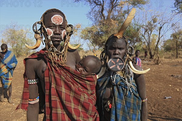 South Ethiopia, in Maco National Park, Mursi tribe, Mursi woman with baby, painted skin and