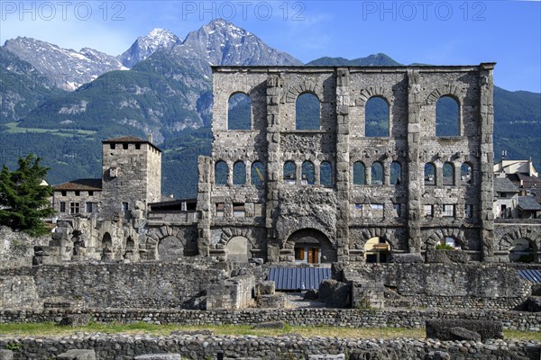 View of facade remains of wall ruins of ancient Roman theatre with window arches in open-air museum
