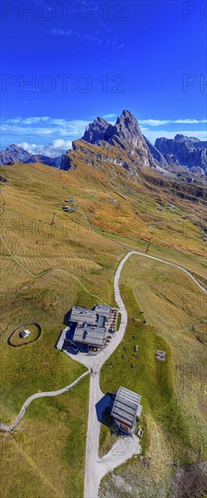 The Sofie hut, behind it the peaks Sas Rigais and Furchetta of the Geisler group, panoramic photo,