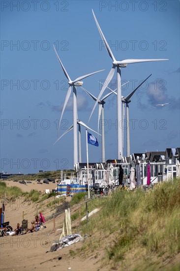 Wind turbines, wind farm, holiday homes, beach houses on the beach of Ijmuiden in North Holland,