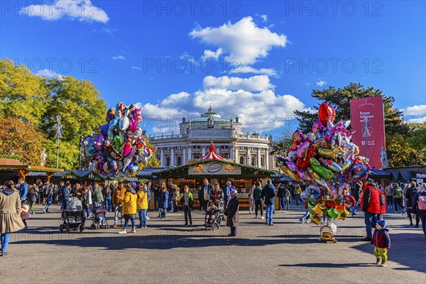 Colourful balloons and visitors at the Christmas market at City Hall, behind the Burgtheater,