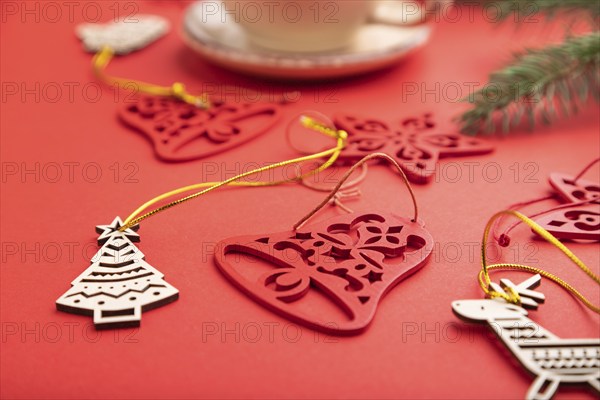 Christmas or New Year composition. Decorations, fir and spruce branches, cup of coffee, on a red