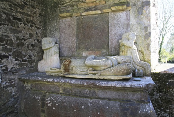 Weathered damaged memorials inside seventeenth century Kilcredan church ruins and graveyard, County