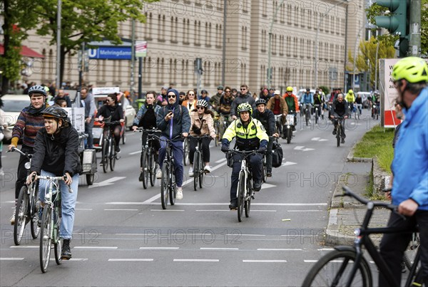 A policewoman from the Berlin bicycle squadron accompanies the bike parade demonstration, Berlin,