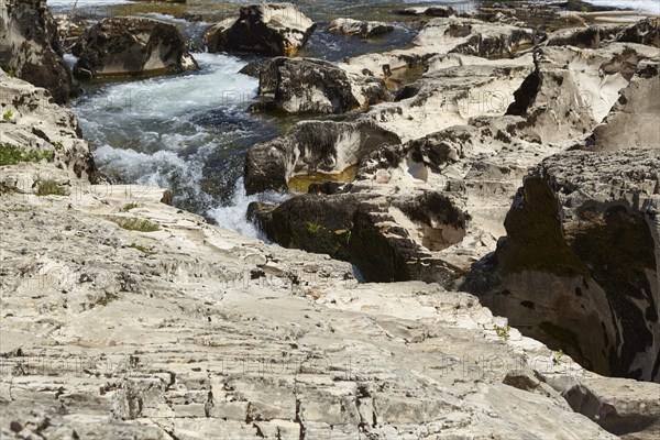 The river Cèze and limestone cliffs form the cascades of Sautadet near La Roque-sur-Cèze,