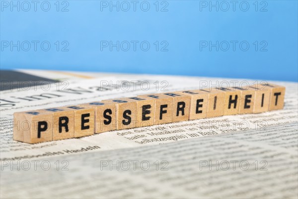 Symbolic image of press freedom: letter cube on a newspaper
