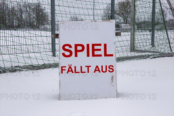 Symbolic image of a football match cancelled due to snow. Sign on a sports field with the