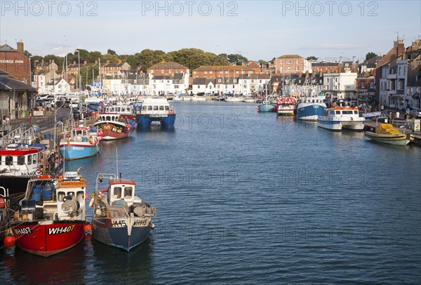 Colourful fishing boats in the harbour at Weymouth, Dorset, England, UK