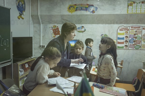 Pupils in a classroom in one of the metro schools in Kharkiv. Classrooms were set up in various