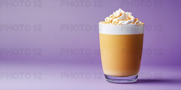 Banner with drinking glass with seasonal pumpkin spice latte on violet background with copy space.