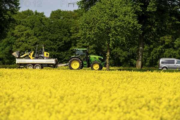 Landscape on the Lower Rhine, Tractor with agricultural machine on the B57 federal road, between