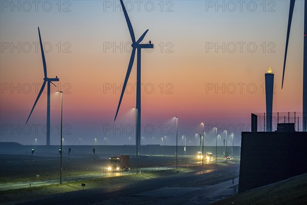 Lorry on the road to Euromax Terminal Rotterdam, ENECO wind farm on the dike around the port of