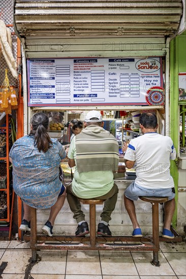 Visitors sitting at a food stall at the counter, Mercado Central de San José, San José, Costa Rica,