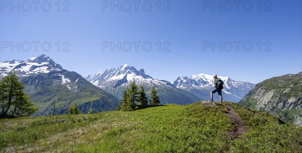 Mountaineer in front of a mountain panorama with glaciated mountain peaks, Aiguille Verte with