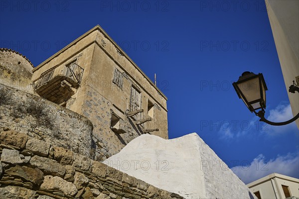 Stone walls and lamp in a Mediterranean village under a blue sky, Colourful mountain village,
