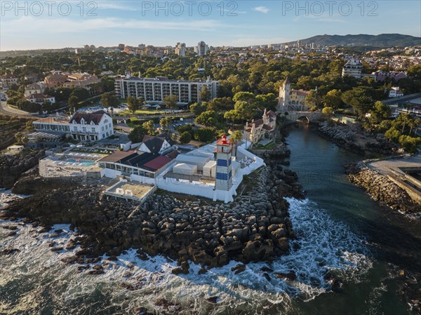 Aerial view of Santa Marta lighthouse and Cascais marina with moored yacht boats with Cascais