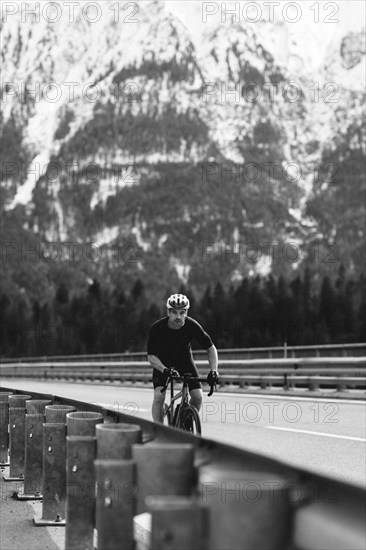 Road bike rider in spring between Lechtal and Tannheimer Tal in front of picturesque scenery of the