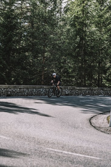 Road bike rider in spring in the Allgäu against the picturesque backdrop of the Alps, Bavaria,