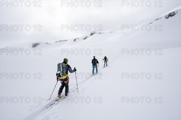 Ski tourer in the fog on the glacier Glacier de la Plaine Morte, mountain landscape with snow,