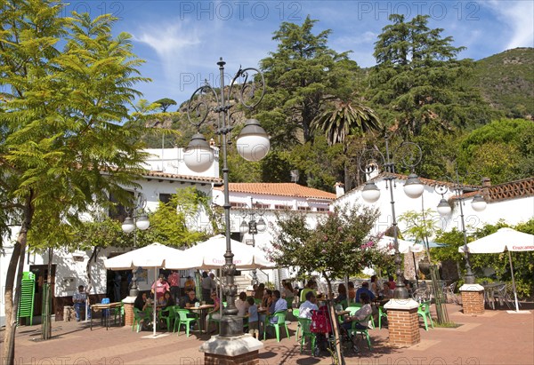 People gathered outside a cafe at Sunday lunchtime village of Alajar, Sierra de Aracena, Huelva