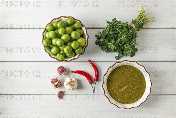 Tkemali sauce, traditional Georgian cuisine, green cherry plum, with ingredients for sauce,