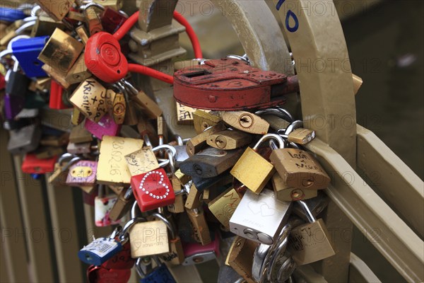 Lover's lock on a railing, love lock is a padlock which, according to custom, is attached to