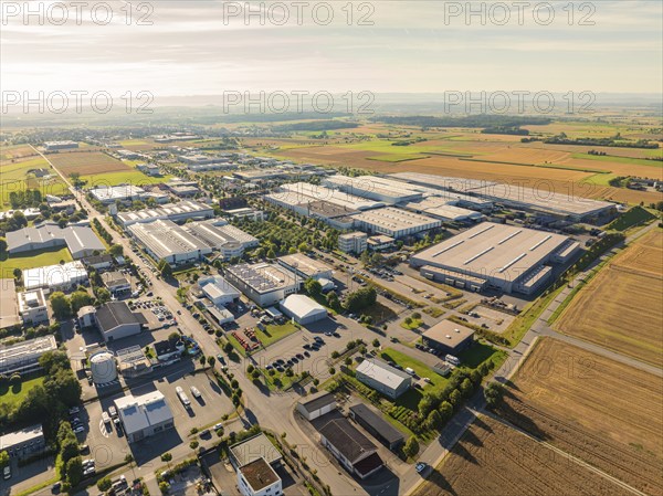 A large industrial area with factories, roads and surrounding fields in a rural area, taken from a