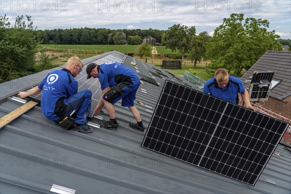 Installation of solar modules on the roof of a barn on a farm, over 240 photovoltaic modules are