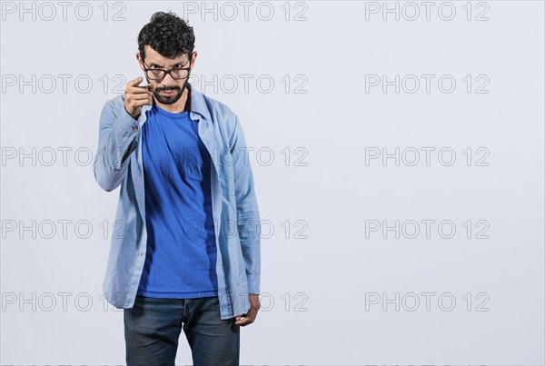 Angry man threatening finger at camera isolated. Concept of angry person threatening head on