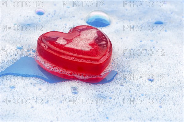 Rose soap in water with foam, Rose soap