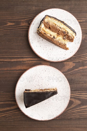 Chocolate biscuit cake with caramel cream on brown wooden background. top view, flat lay