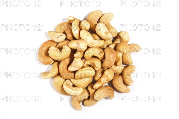 Pile of sweet cashew nuts isolated on white background. Top view