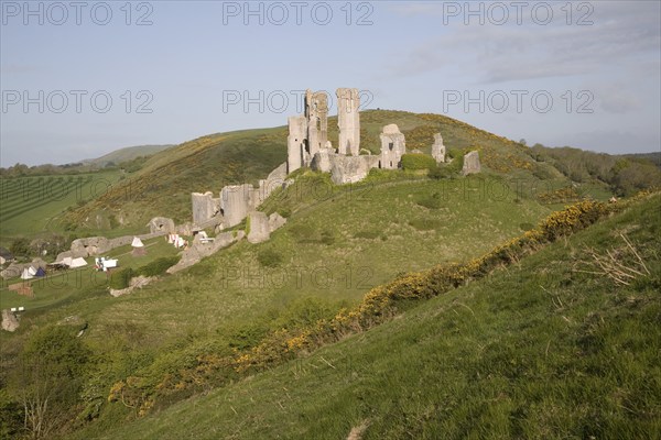 Corfe Castle is located in a natural defensive site on a hill between chalk ridges and for a