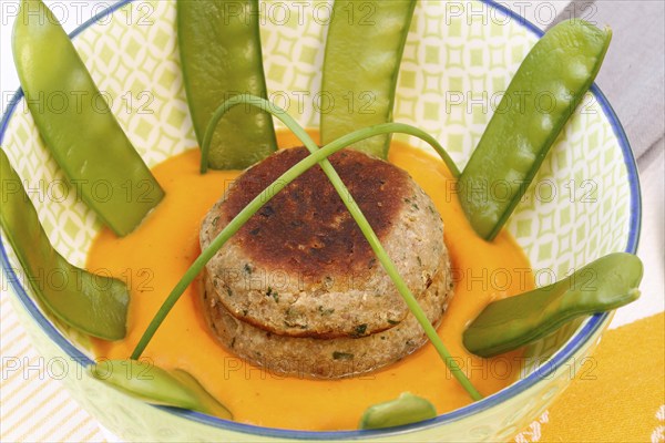 Vegetarian cuisine, walnut cakes on sugar snap peas with pumpkin sauce, sauce, vegetables, snow