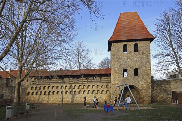 Historic town fortifications with pigeon tower and children's playground, town wall with