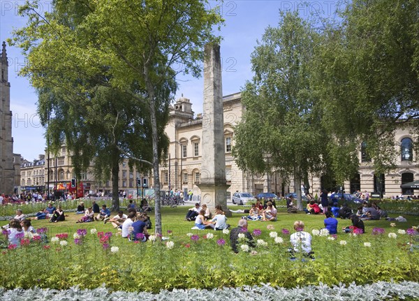 People enjoying summer sunshine on the grass at Orange Grove, Bath, Somerset, England, United