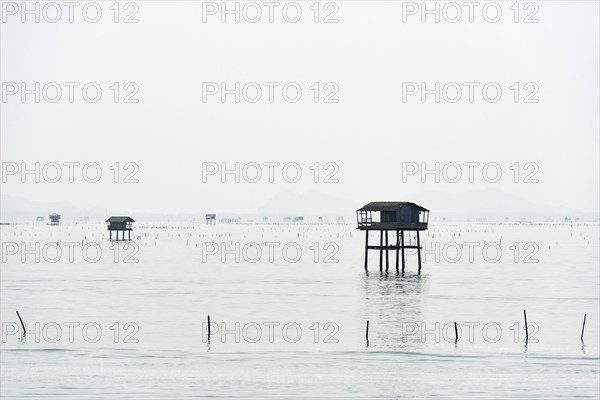 Traditional wooden huts of fishermen in the Gulf of Thailand in the morning haze, fisherman,