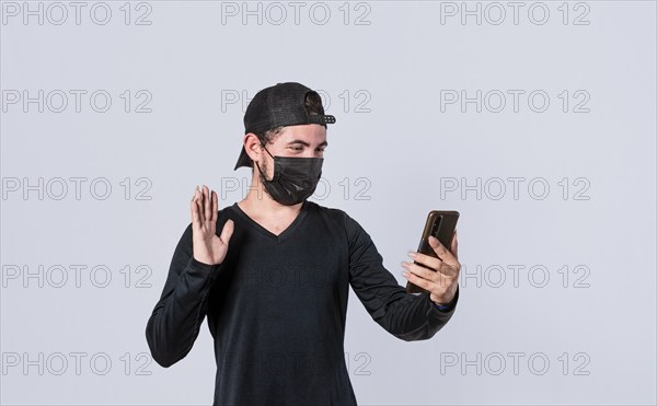 Man making video call isolated, guy making video call with face mask, face mask video call concept