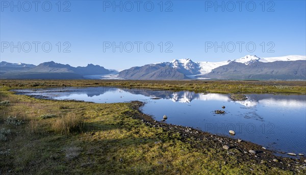 Lake with reflection, view of glacier tongues Skaftafellsjökull and Svínafellskökull, glaciated