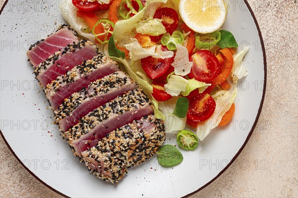 Fillet of red tuna meat, fried in sesame seeds, homemade, close-up, no people, on a wooden