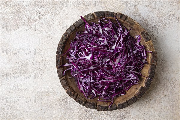 Red cabbage, sliced, in a wooden salad bowl, top view, no people